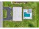 Aerial view showing building, parking, and community pool at 235 Rotonda Blvd W # C203, Rotonda West, FL 33947