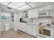 White kitchen features stainless steel appliances and ample cabinet space at 235 Rotonda Blvd W # C203, Rotonda West, FL 33947