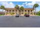Building exterior featuring Spanish-style architecture and ample parking at 235 Rotonda Blvd W # C203, Rotonda West, FL 33947