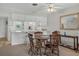 Cozy dining area with a round wooden table and four chairs at 235 Rotonda Blvd W # C203, Rotonda West, FL 33947