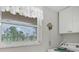Laundry room features a window overlooking a lush green view at 235 Rotonda Blvd W # C203, Rotonda West, FL 33947