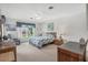 Bright bedroom with a queen-size bed and window at 235 Rotonda Blvd W # C203, Rotonda West, FL 33947