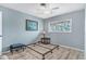 Blue bedroom with wood-look flooring, ceiling fan, and walk-in closet at 235 Rotonda Blvd W # C203, Rotonda West, FL 33947