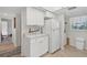 White kitchen with marble countertops and a full-size refrigerator at 235 Rotonda Blvd W # C203, Rotonda West, FL 33947