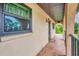 Condo hallway with tiled floors and access to unit at 235 Rotonda Blvd W # C203, Rotonda West, FL 33947