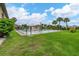 Community pool with grassy area and building in background at 235 Rotonda Blvd W # C203, Rotonda West, FL 33947