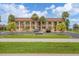 Front view of condo building with parking and landscaping at 235 Rotonda Blvd W # C203, Rotonda West, FL 33947