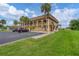 Condo building showcasing its side profile and landscaping at 235 Rotonda Blvd W # C203, Rotonda West, FL 33947