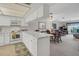 White kitchen with marble countertops and open to living room at 235 Rotonda Blvd W # C203, Rotonda West, FL 33947