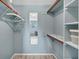Spacious walk-in closet with ample shelving and hanging rods at 235 Rotonda Blvd W # C203, Rotonda West, FL 33947