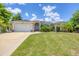 Single-story home with a two-car garage and well-manicured lawn at 639 Boundary Blvd, Rotonda West, FL 33947