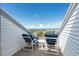Relaxing deck overlooking the ocean with chairs and small table at 7104 Palm Island Dr # Le38, Placida, FL 33946