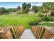 Wooden stairs leading to a grassy backyard with palm trees and ocean view at 7104 Palm Island Dr # Le38, Placida, FL 33946