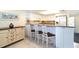 White kitchen with granite countertops and a breakfast bar with three stools at 7104 Palm Island Dr # Le38, Placida, FL 33946