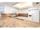 Bright white kitchen with granite countertops, ample cabinetry, and stainless steel appliances at 7104 Palm Island Dr # Le38, Placida, FL 33946