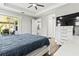 Main bedroom with sliding glass doors to the patio, a dresser, and a large TV at 9239 Harvester St, Port Charlotte, FL 33981