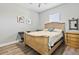 Guest bedroom with a wooden bed frame, dresser, and a large window at 9239 Harvester St, Port Charlotte, FL 33981