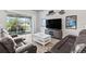 Living room with two leather sofas, a coffee table, and sliding glass doors at 9239 Harvester St, Port Charlotte, FL 33981