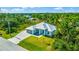 Single-story home with metal roof, driveway, and large backyard at 9239 Harvester St, Port Charlotte, FL 33981