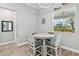 Small dining area with round table and four gray chairs at 9239 Harvester St, Port Charlotte, FL 33981