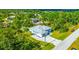 Aerial view of a single-Gathering home with a metal roof and a large backyard at 9239 Harvester St, Port Charlotte, FL 33981