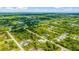 Aerial view of a residential community, showcasing various houses and surrounding landscape at 9239 Harvester St, Port Charlotte, FL 33981
