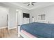 Main bedroom with large bed, dresser, and access to the bathroom at 9239 Harvester St, Port Charlotte, FL 33981
