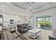 Spacious living room with leather couches, sliding glass doors, and access to the patio at 9239 Harvester St, Port Charlotte, FL 33981