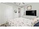 Bedroom with a queen-size bed, white dresser, and large TV at 9239 Harvester St, Port Charlotte, FL 33981