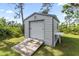 Outdoor storage shed with roll-up door and wooden ramp at 9239 Harvester St, Port Charlotte, FL 33981