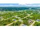 Aerial view of a residential community featuring numerous houses and lush green landscape at 9239 Harvester St, Port Charlotte, FL 33981