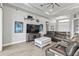 Spacious living room with leather seating, large TV, and coastal decor at 9239 Harvester St, Port Charlotte, FL 33981