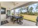 Covered patio with outdoor dining set, ideal for relaxing and entertaining at 9239 Harvester St, Port Charlotte, FL 33981
