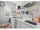 Laundry room with washer, dryer, utility sink, and ample shelving at 9239 Harvester St, Port Charlotte, FL 33981