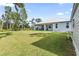 Home's backyard features a patio and grassy area at 9239 Harvester St, Port Charlotte, FL 33981