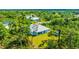 Single-Gathering home backyard with green grass and trees at 9239 Harvester St, Port Charlotte, FL 33981
