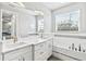 Double vanity bathroom with a soaking tub and neutral color palette at 9239 Harvester St, Port Charlotte, FL 33981