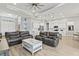 Open living room featuring a spacious layout with comfortable seating and large windows at 9239 Harvester St, Port Charlotte, FL 33981