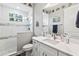 Bathroom with a walk-in shower, white cabinets, and coastal decor at 9239 Harvester St, Port Charlotte, FL 33981