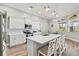 Modern kitchen with white shaker cabinets, quartz countertops, and stainless steel appliances at 9239 Harvester St, Port Charlotte, FL 33981
