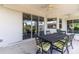 Covered patio with outdoor dining set and sliding glass doors at 9239 Harvester St, Port Charlotte, FL 33981