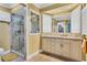 Bright bathroom features a glass shower, neutral vanity with marble countertop and plenty of storage at 2516 Dixon Ter, Port Charlotte, FL 33981