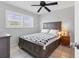 Bedroom featuring a ceiling fan, tiled floor and window with plantation shutters for natural light and privacy at 2516 Dixon Ter, Port Charlotte, FL 33981