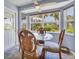 Cozy breakfast nook with a glass table, unique wooden chairs, and a view of the lush backyard at 2516 Dixon Ter, Port Charlotte, FL 33981