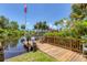 This dock features a wooden bench and fence overlooking the water, providing a peaceful retreat by the water at 2516 Dixon Ter, Port Charlotte, FL 33981