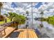 Waterfront dock offering serene water views, completed with wooden flooring and convenient boat mooring facilities at 2516 Dixon Ter, Port Charlotte, FL 33981