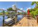 Waterfront wooden dock with boat lift and outdoor seating provides stunning views, perfect for relaxation and entertainment at 2516 Dixon Ter, Port Charlotte, FL 33981