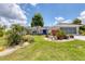 Charming single-story home features lush landscaping and a bright blue front door at 2516 Dixon Ter, Port Charlotte, FL 33981