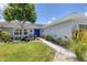 Charming single-story home with lush landscaping and a walkway leading to the front door at 2516 Dixon Ter, Port Charlotte, FL 33981