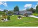 Beautiful home with lush green lawn, colorful landscaping, and a screened garage at 2516 Dixon Ter, Port Charlotte, FL 33981